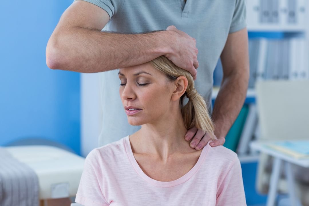Physiotherapist treating a patient's knee.
